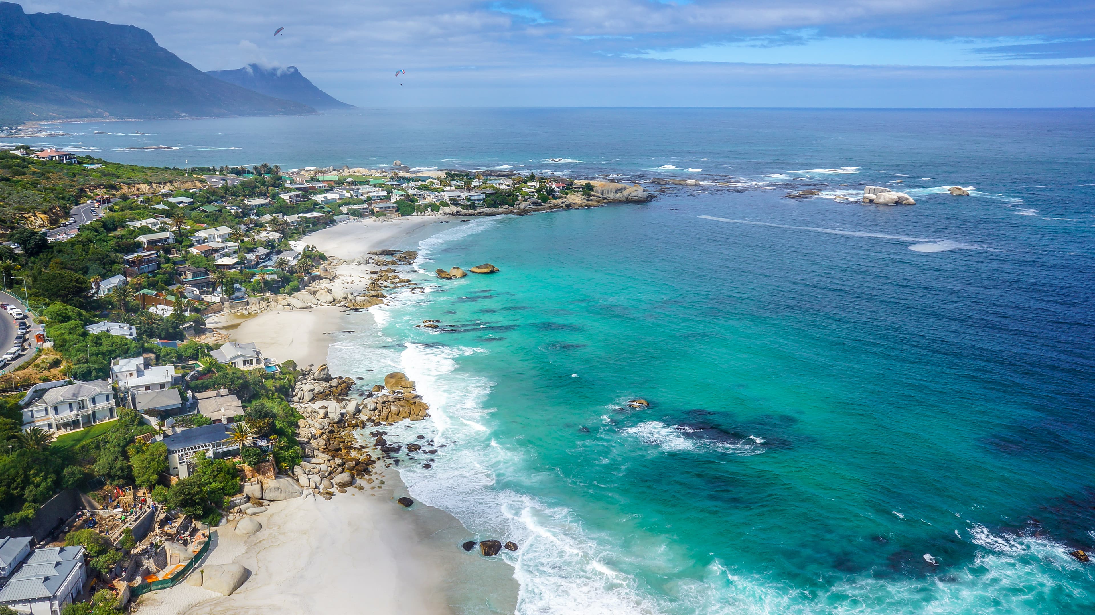 Aerial view of Clifton's sheltered beaches and boulder-divided coves along the Atlantic coastline of Cape Town, South Africa