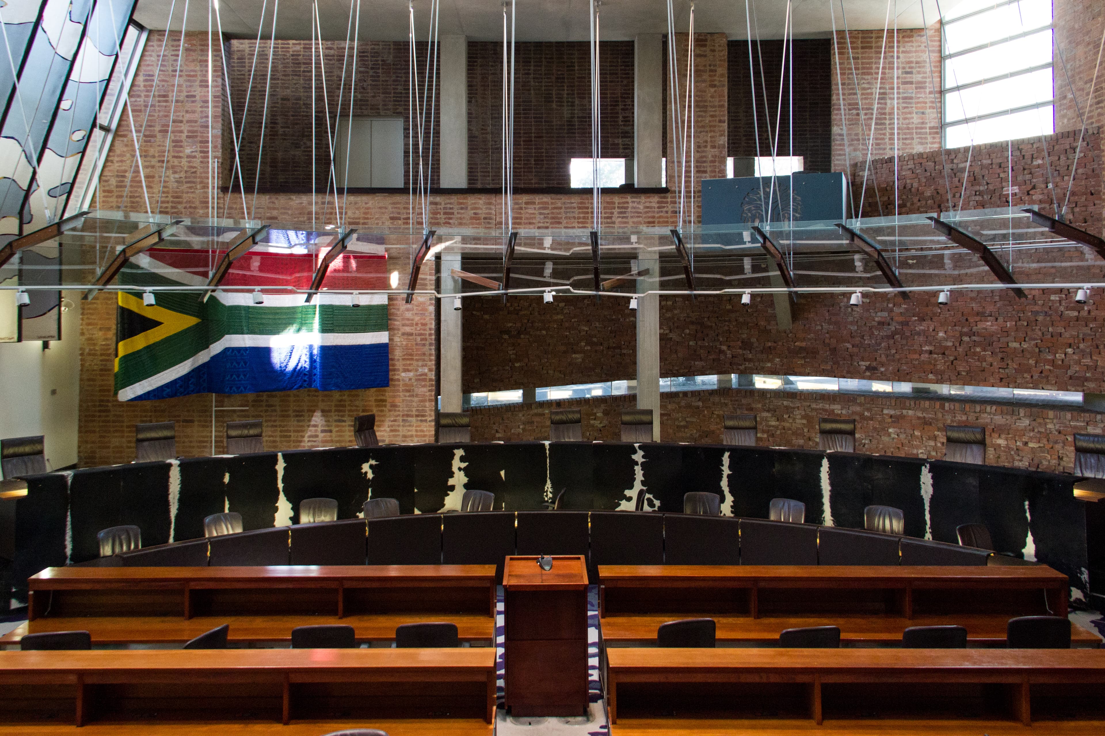 Exterior of the Constitutional Court of South Africa at Constitution Hill, Johannesburg, with its distinctive concrete columns and carved wooden entrance doors.