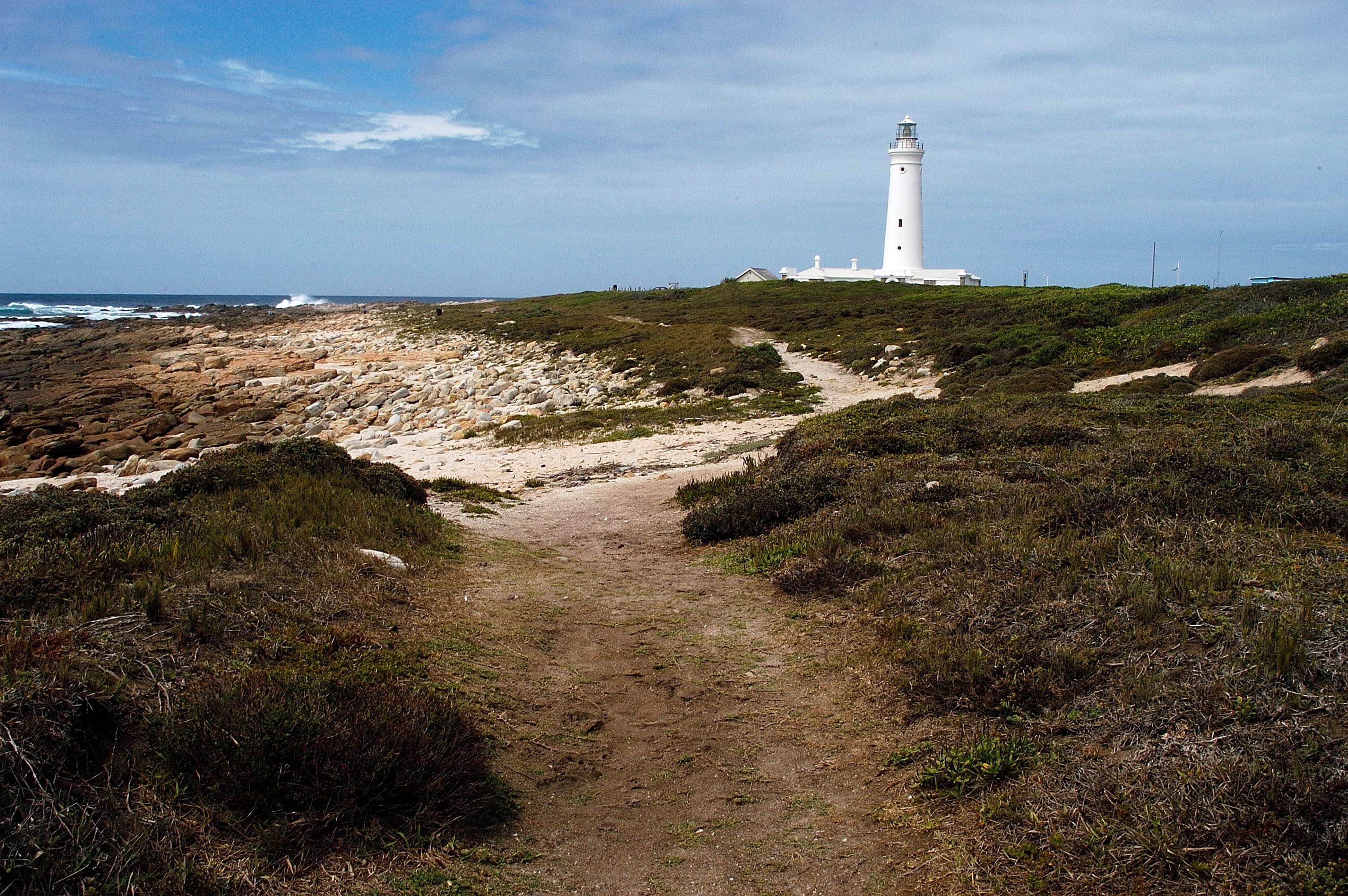 Seal Point lighthouse standing on the rocky shoreline at Cape St Francis, Eastern Cape, South Africa