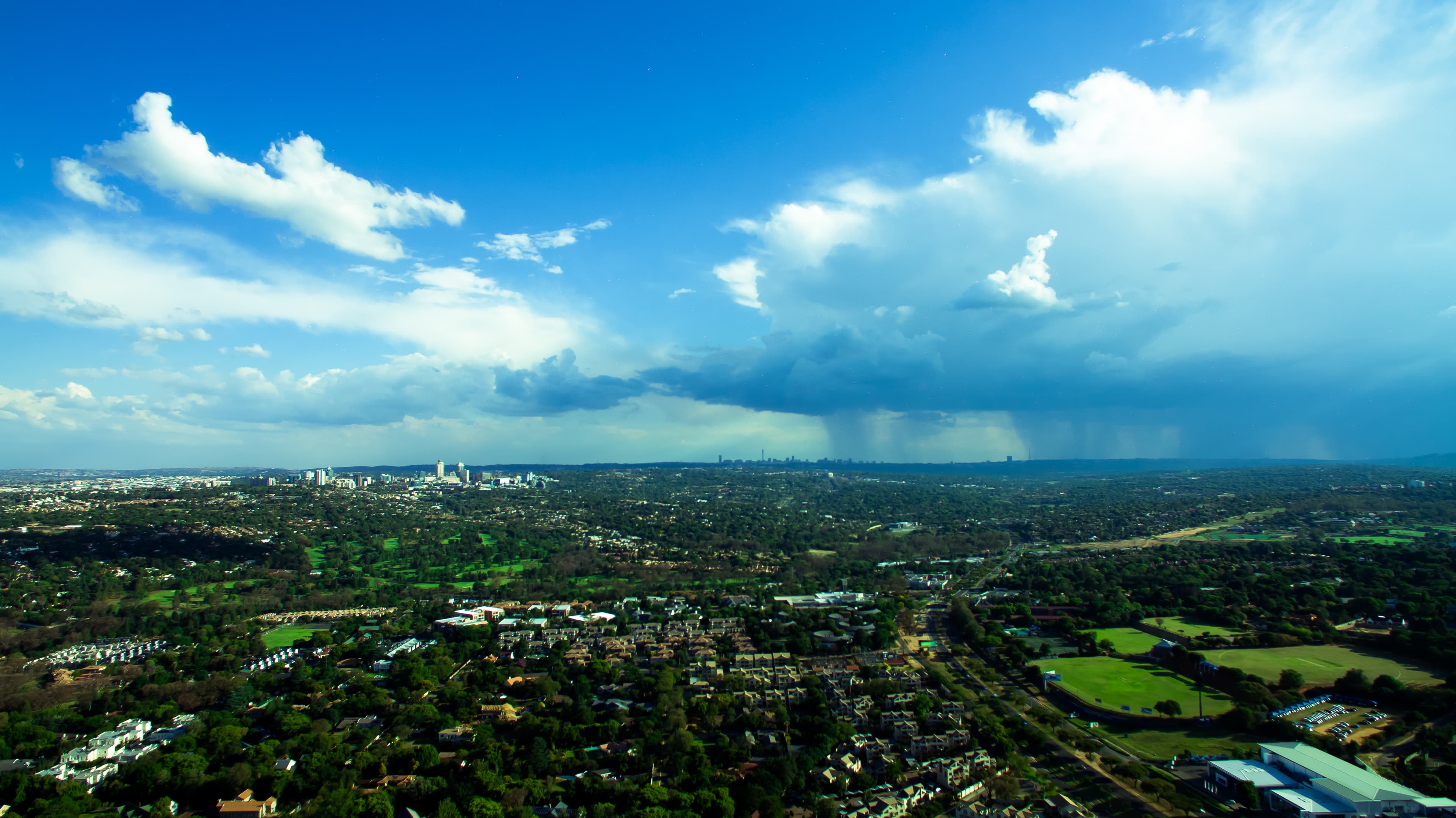 Aerial view of Johannesburg tree-filled cityscape and skyline on a summer day
